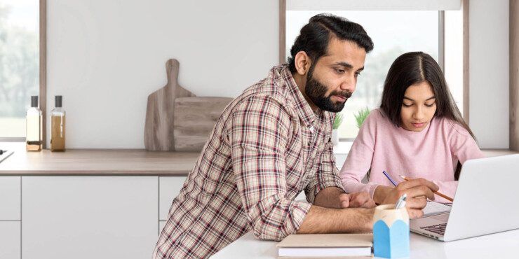Father and daughter looking at a lap top