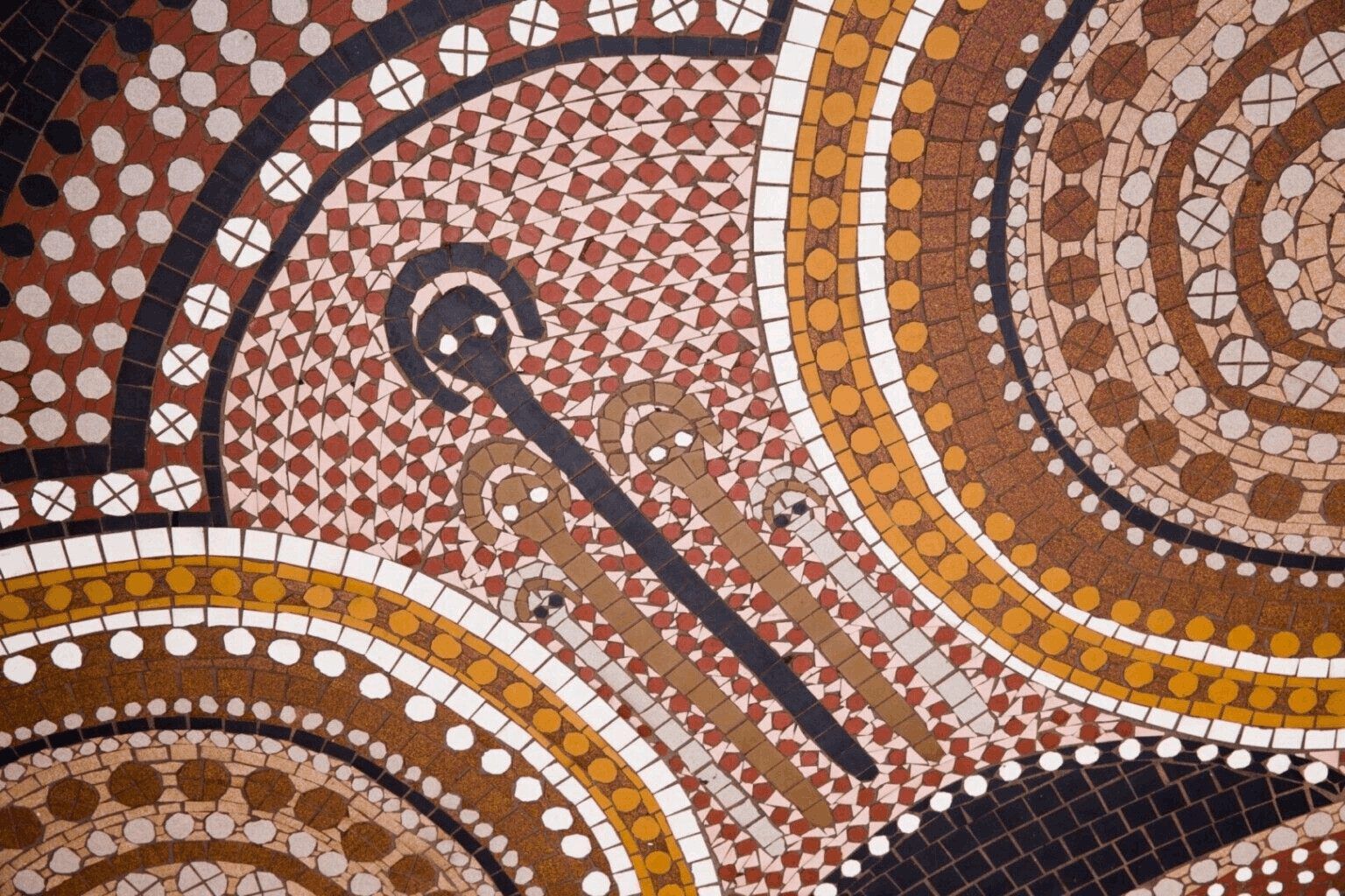 Aboriginal dot-painting artwork in ochre, brown and white tones, featuring concentric circles and a curved travelling line