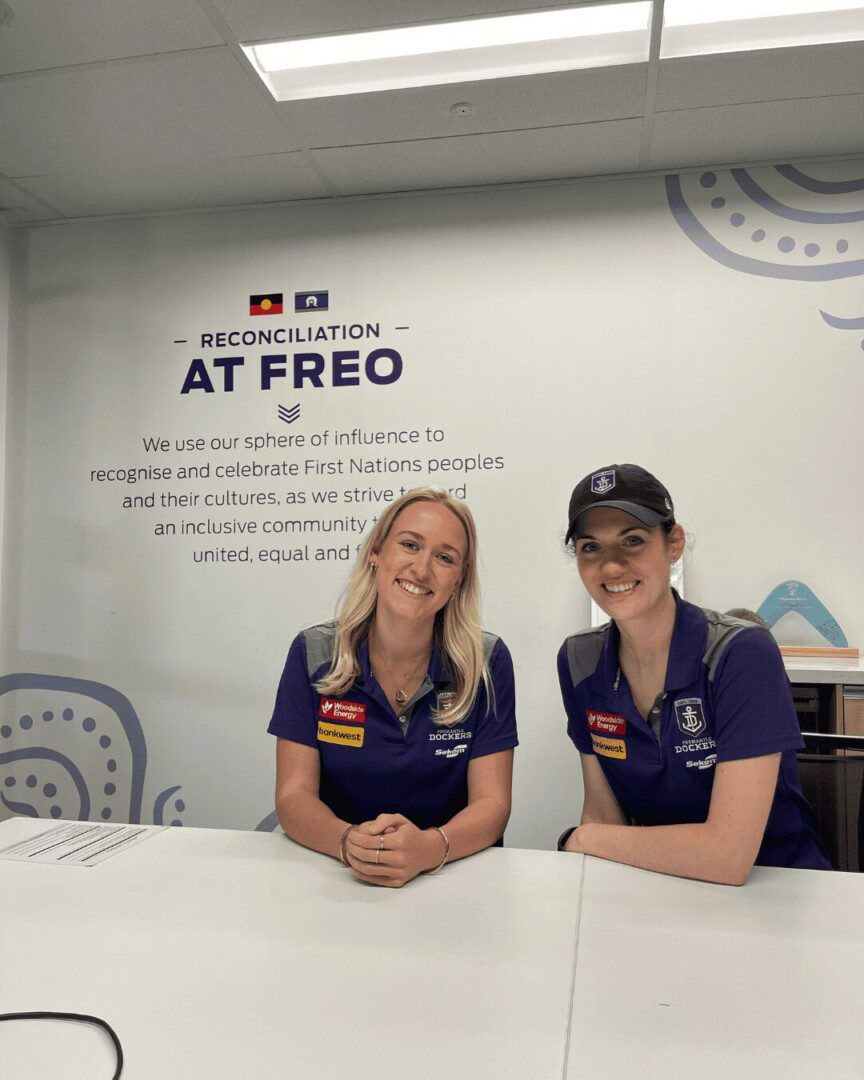 Two women in Fremantle shirts smiling.